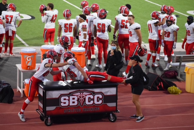 Athletic trainer helping a player